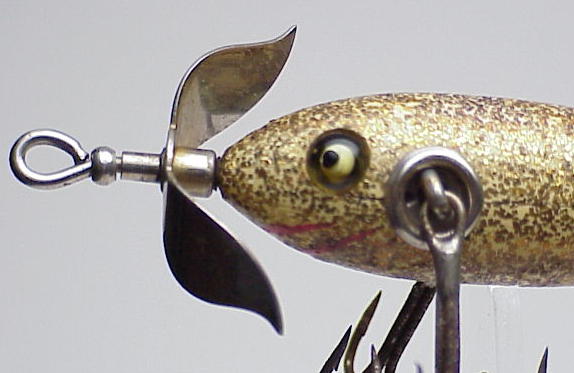 Help identify this vintage lure (the bottom one) it's about 3.5 inches long.  Reverse image search did not yield this exact lure for me. I've identified  11 other vintage lures from this